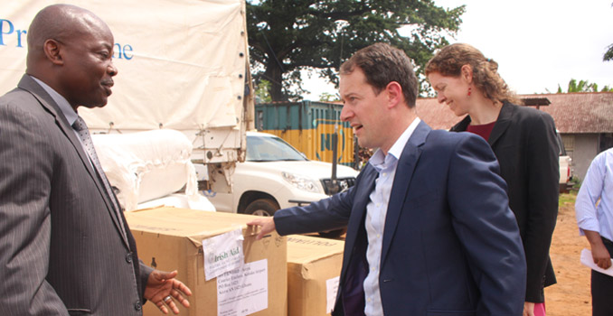 Minister Seán Sherlock with Gon Myers, WFP Country Rep at the Freetown WFP warehouse with Irish Aid stocks