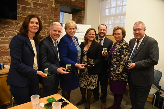 Minister Humphreys, Consul General, Speaker and Irish Caucus members showing their gift - commemoration coin